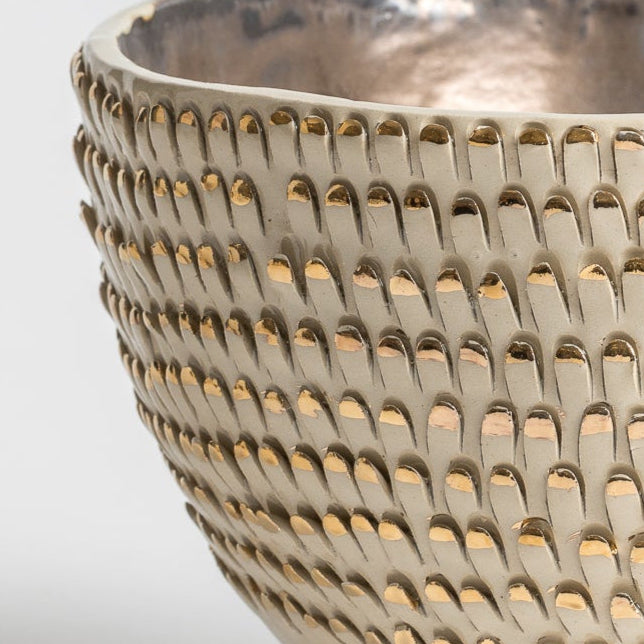 white and gold spiky vessel