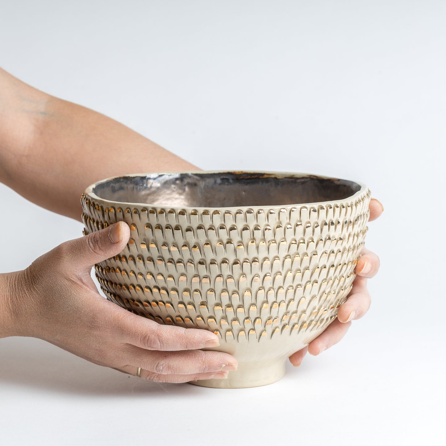 white and gold spiky vessel