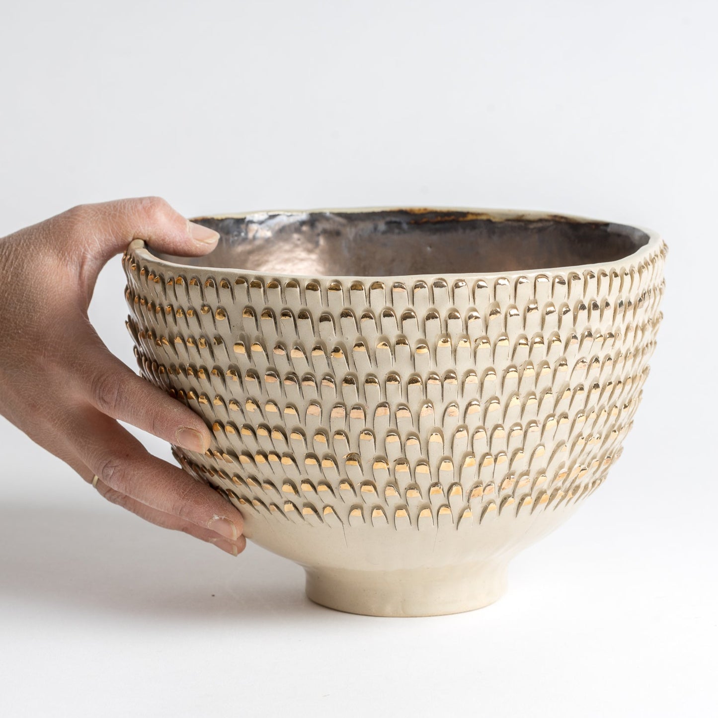 white and gold spiky vessel